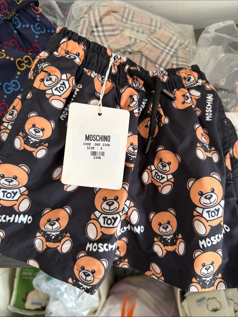 Kids Black Swim Shorts with Orange Teddy Print